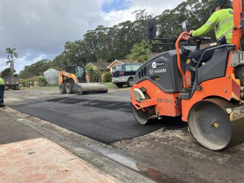 road works heavy machinery rolling new road pavement