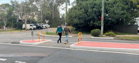 enhanced road safety on Mount Ettalong Umina Man and woman walking across road with pedestrian island