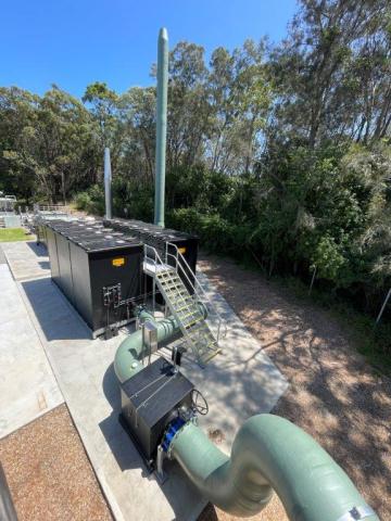 Bateau Bay Sewage Treatment plant upgrade A large green pipe connected to a green hose, showcasing a robust and functional design for fluid transport.