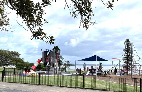 Picnic Point playspace Picnic Point playspace with play equipment including swing sets, slides, a multi-level climbing structure, obstacle course, flying fox, a junior climbing unit, shade, fence and rope climbing unit.