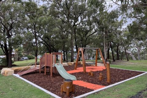 Arlington Reserve playspace Image showing new play equipment at Arlington Reserve nature playspace including a play unit with a slide, jungle drum, basket swing, log stepper balance rope, rubber softfall and mulch.