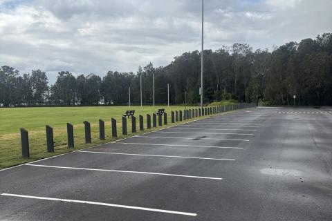 Don Small Oval Tacoma car park Car park with white markings and oval and trees in the background.