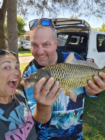 Some of the keen fishers who captured carp during the program. After a quick kiss the carp were off to Elvis the croc to give these pest fish an entirely different kind of attention! Two people holding a carp